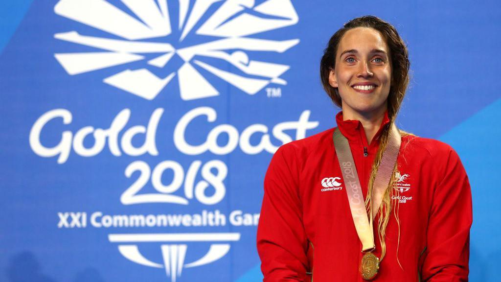 Alys Thomas on the podium at the Commonwealth Games on the Gold Coast in 2018 having won a gold medal in the 200m butterfly. 