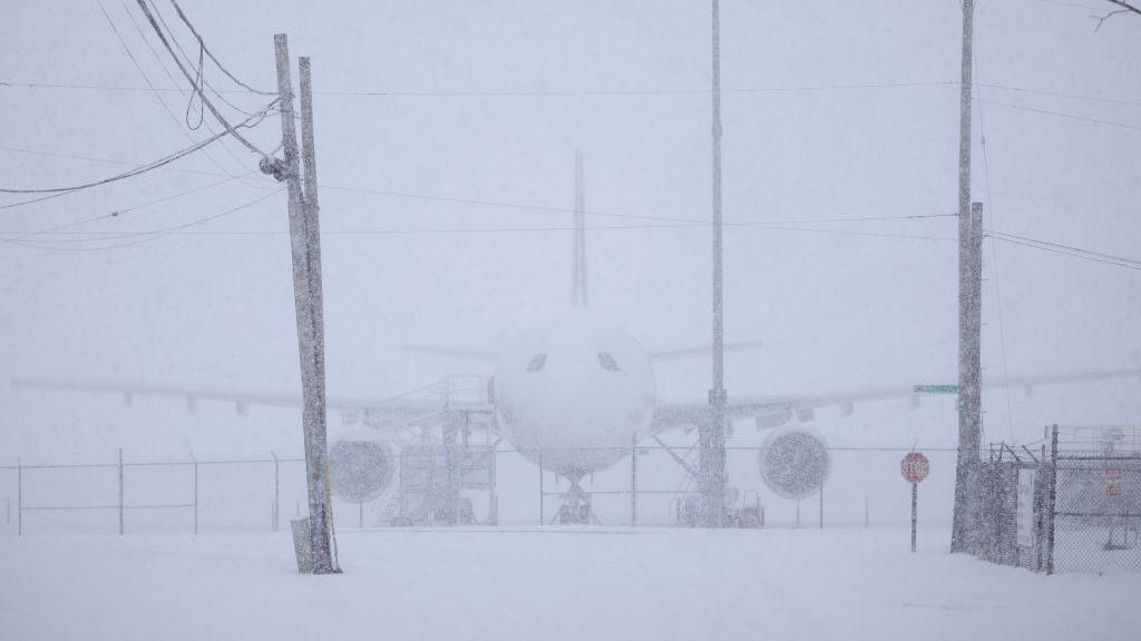 Plane covered in snow.