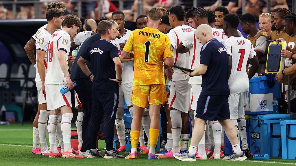 England players gather on the touchline for a hydration break during the 4-2 victory over Croatia at the 2026 FIFA World Cup in Dallas, Texas