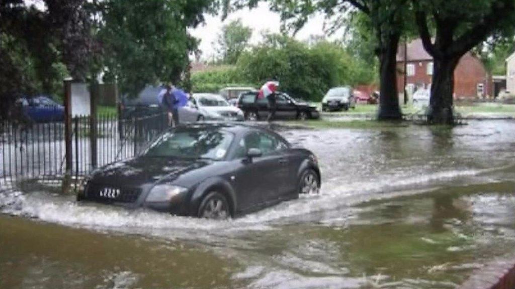 Car driving through flooded road