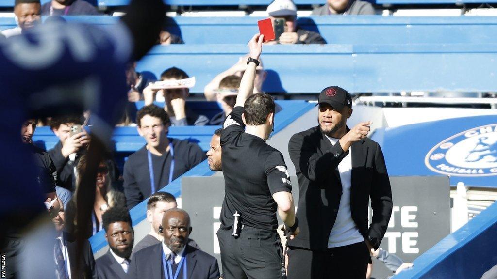 Vincent Kompany is shown a red card by referee Darren England