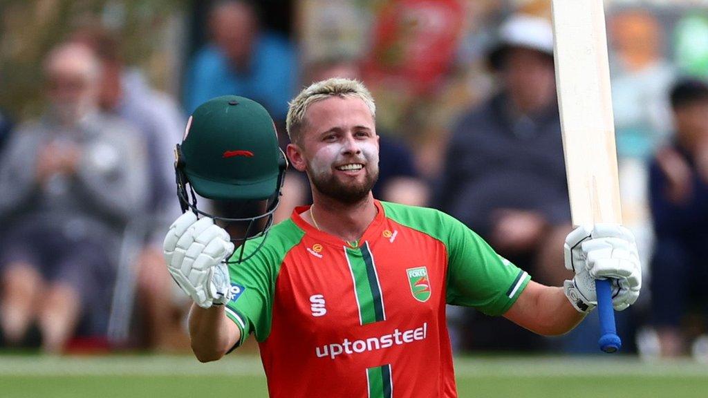 Leicestershire's Sol Budinger raises his bat to acknowledge his first ton in professional cricket