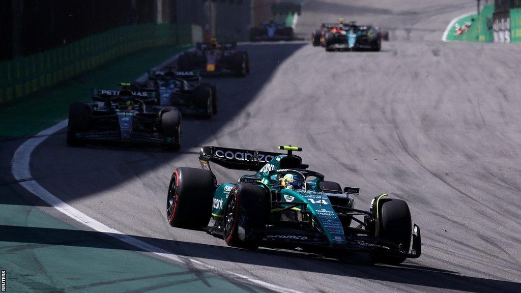 Aston Martin's Fernando Alonso leads a train of cars at the Sao Paulo Grand Prix, including Mercedes' Lewis Hamilton