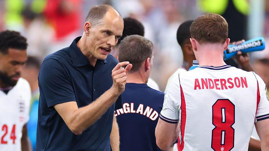 Elliot Anderson receives instructions from England manager Thomas Tuchel