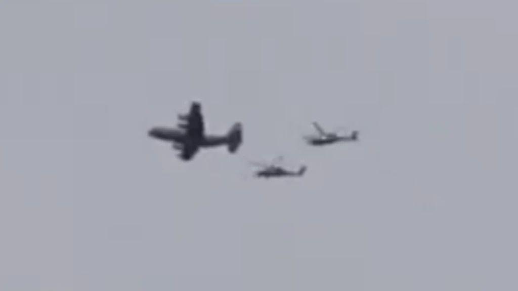 A still of a video showing what appears to be a US plane accompanied by two helicopters flying over southern Iran