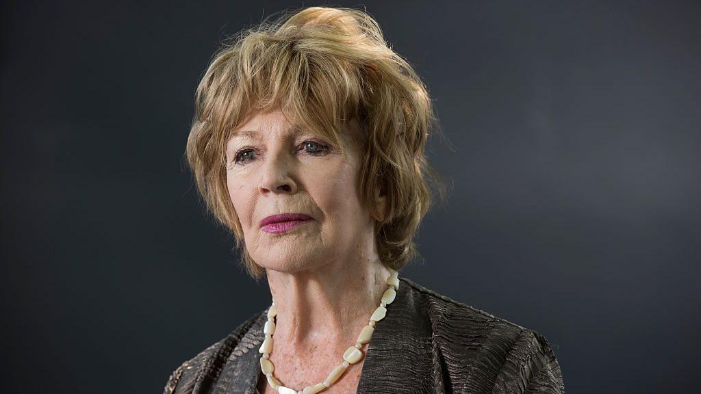 Headshot of Edna O'Brien against a grey background