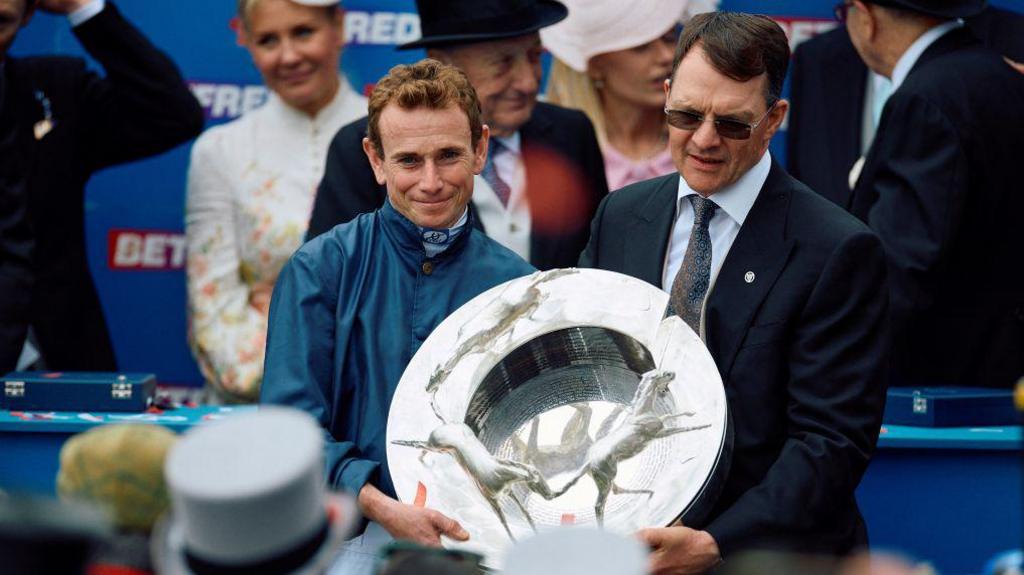 Ryan Moore and Aidan O'Brien celebrate winning the 2024 Derby