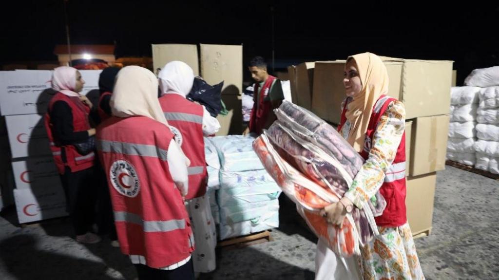 Egyptian Red Crescent Society employees handle humanitarian aid bound for Palestinians of the Gaza Strip, at a warehouse in Arish, Egypt, on 23 October 2023.