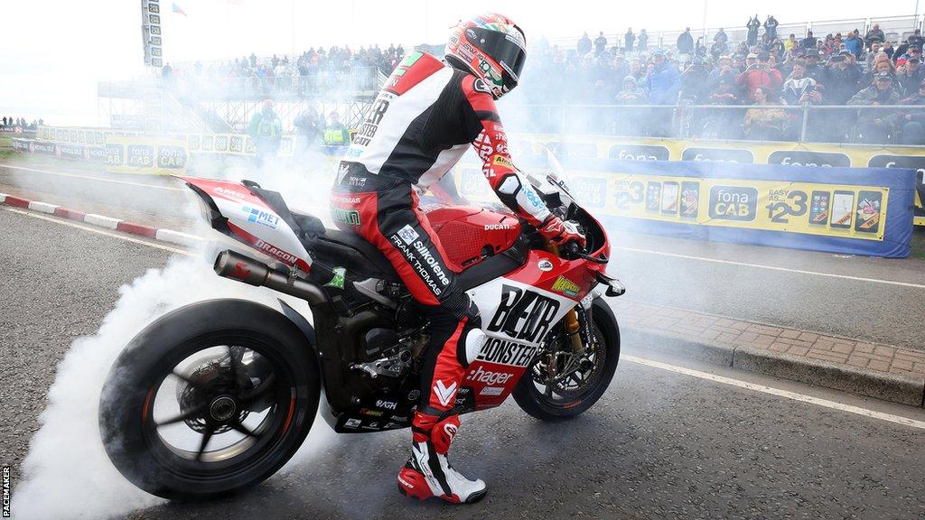 Glenn Irwin celebrates his win with a burnout