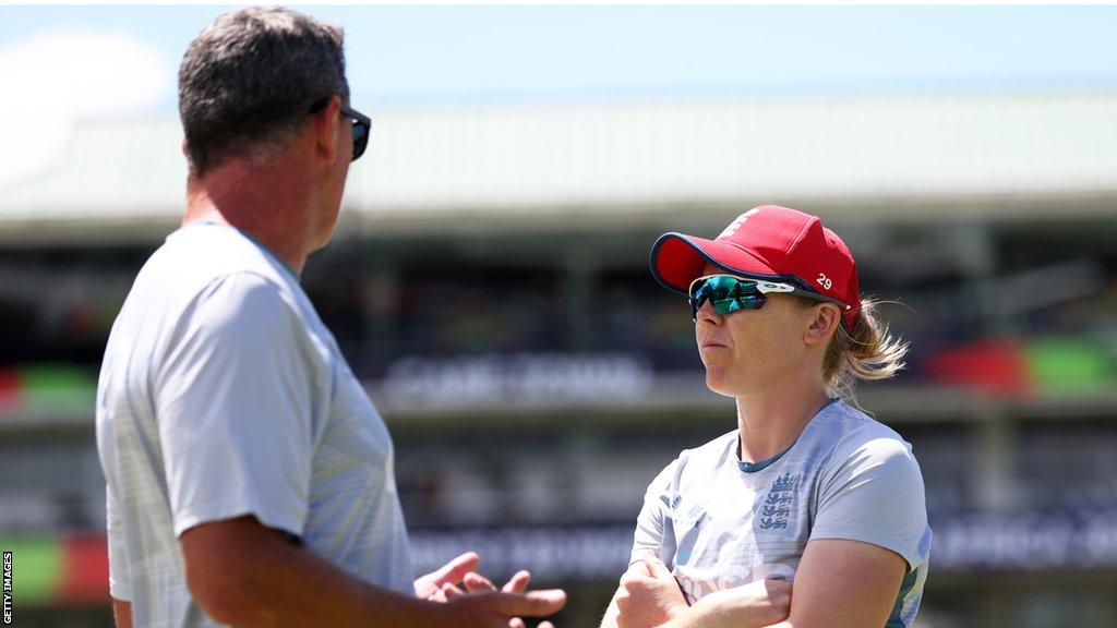 Jon Lewis (L) in conversation with England captain Heather Knight (R)