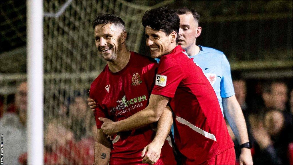 Luke Bowen celebrates after scoring his and Briton Ferry Llansawel's third goal