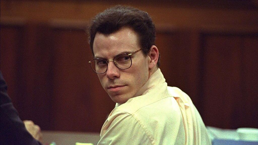 File image of Erik Menendez in a court room, dressed in yellow shirt and glasses