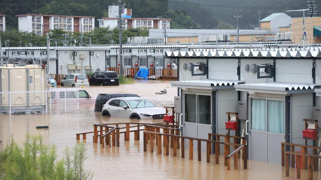 This photo shows temporary housing - built for people who lost their homes during the January 1, 2024 earthquake - surrounded by floodwaters after heavy rains pounded the area, in Wajima