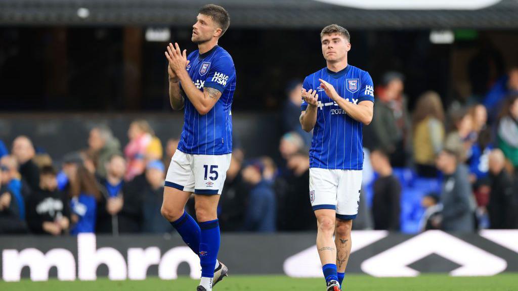 Leif Davis and Cameron Burgess clapping the fans at full time.