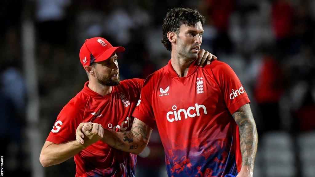 Chris Woakes (left) congratulates England team-mate Reece Topley (right) on taking a wicket v West Indies