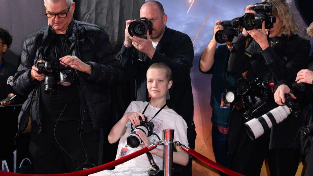 Liz Hatton (C) works alongside the press photographers during the UK Premiere of "Venom: The Last Dance" at the BFI IMAX Waterloo on October 23, 2024 in London, England