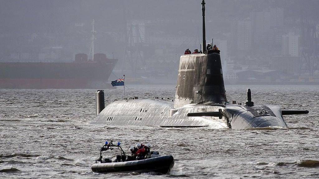 HMS Astute, the first of the Astute class attack submarines, leaving the Clyde with a Royal Navy dinghy escort. 