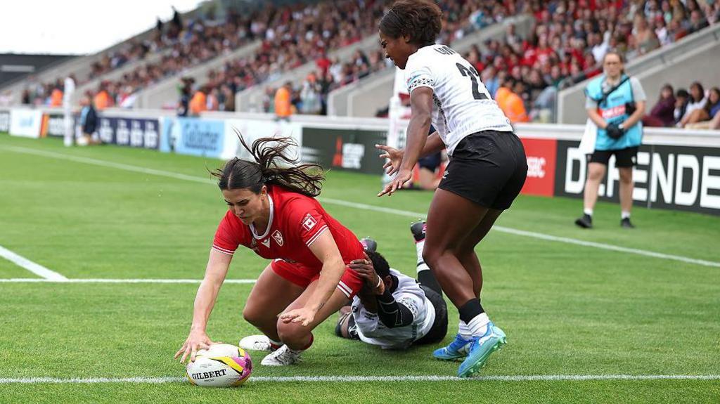 Julia Schell touches the ball down for a try