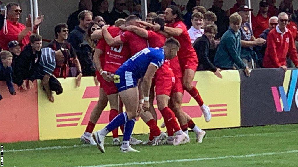 Jersey Reds celebrate Scott van Breda's early try