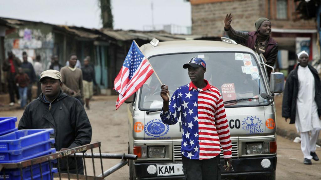 A man waving a US flag in Kibera slum in Kenya's capital, Nairobi - 2015