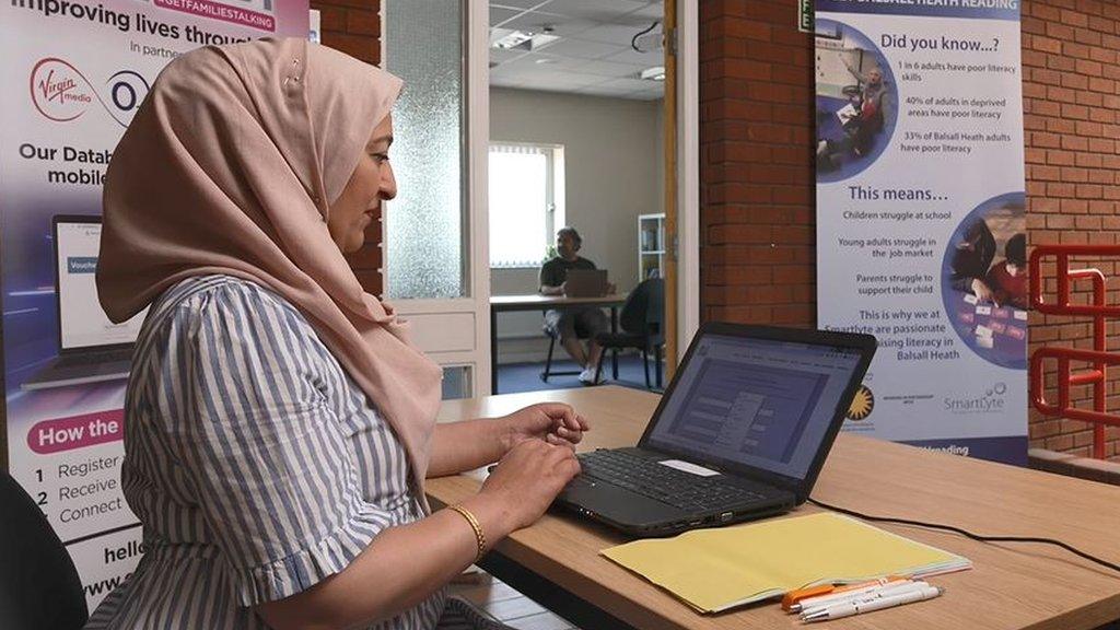 A worker waits to help people with data