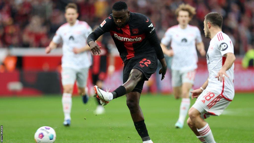 Victor Boniface shoots while playing for Bayer Leverkusen