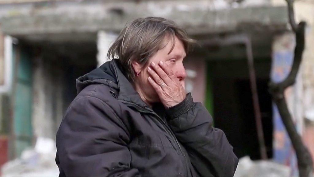 Tatyana, a Mariupol resident sits surrounded by her wrecked neighbourhood