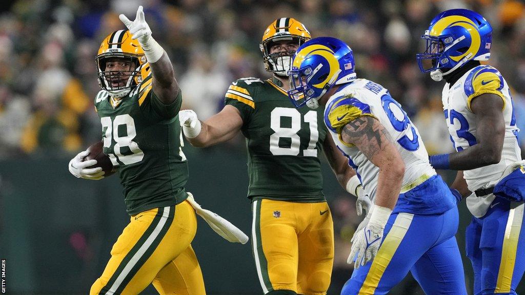 AJ Dillon celebrates a touchdown