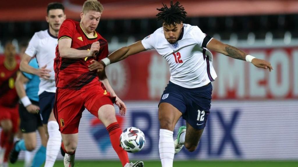 England's Tyrone Mings takes on Belgium's Kevin de Bruyne