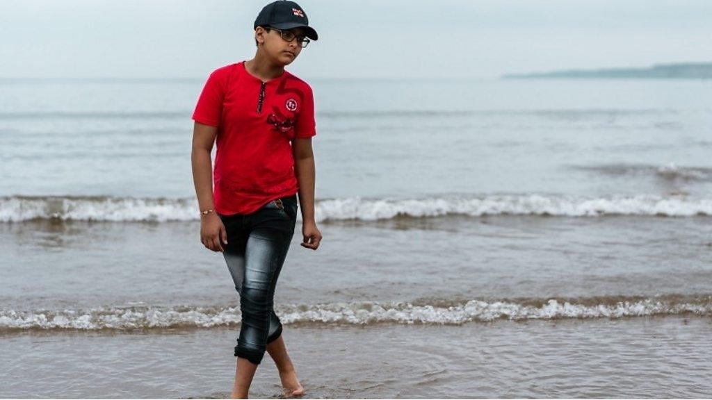 Boy paddling in the sea