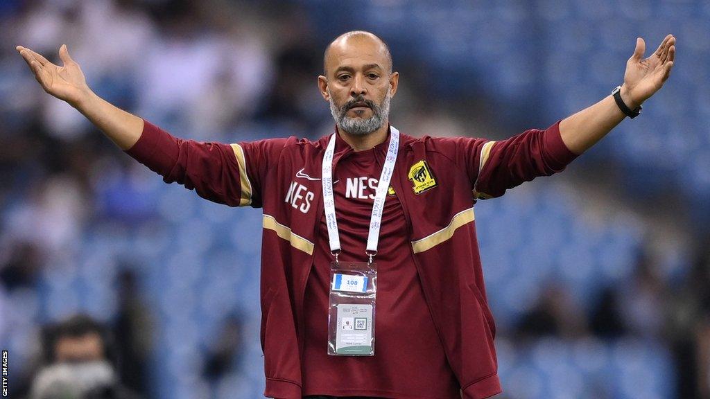 Nuno Espirito Santo with arms raised on touchline duty