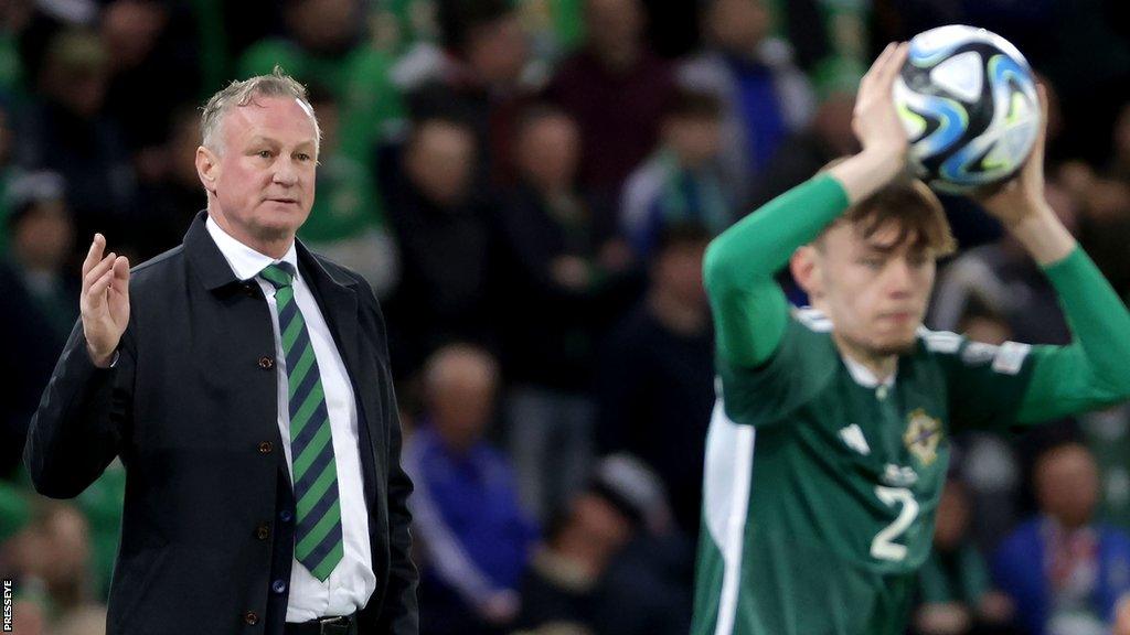 Michael O'Neill watches a Conor Bradley takes a throw-in