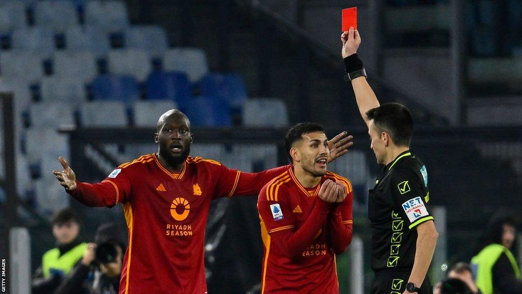 Roma's Romelu Lukaku holds both arms out in disbelief as the referee shows him a red card in the Serie A game against Fiorentina