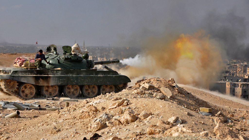 A Syrian army tank fires on Islamic State group militants in Deir al-Zour in late 2017