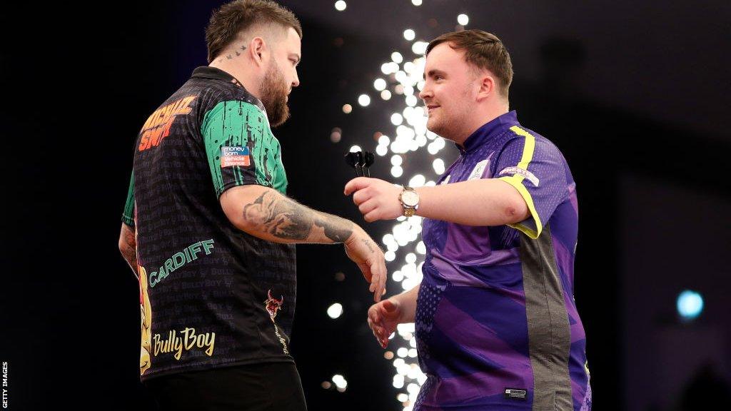 Michael Smith (left) and Luke Littler hug after their Premier League Darts match