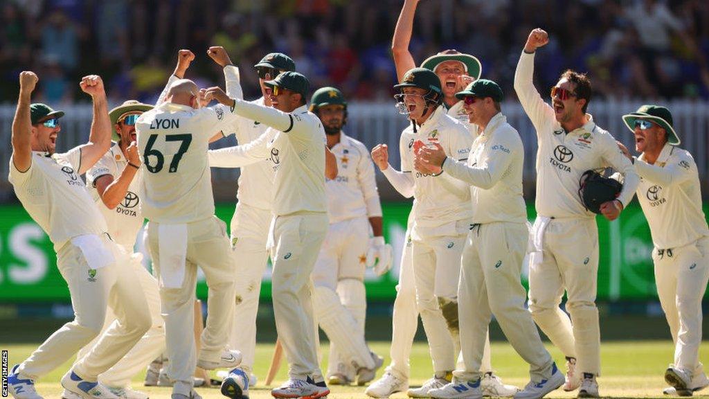 Nathan Lyon celebrates taking his 500th Test wicket