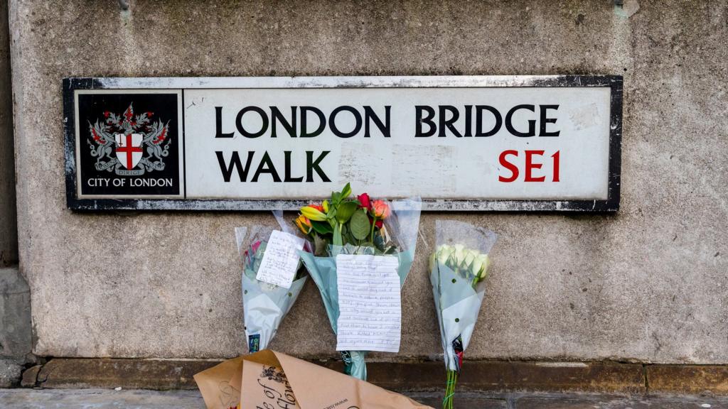 London Bridge sign and flowers