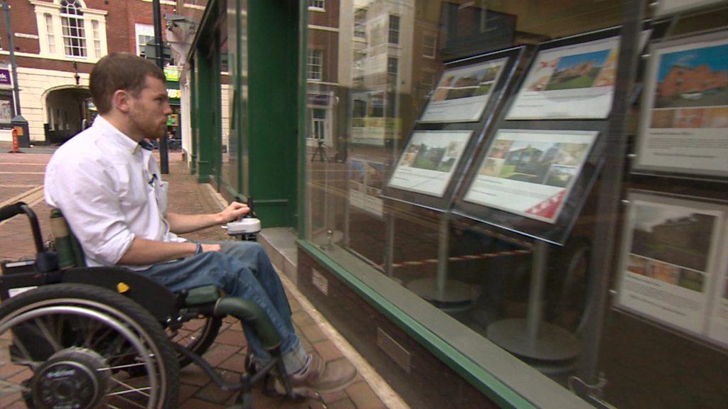 Ellis Palmer looks in the window of a letting agent