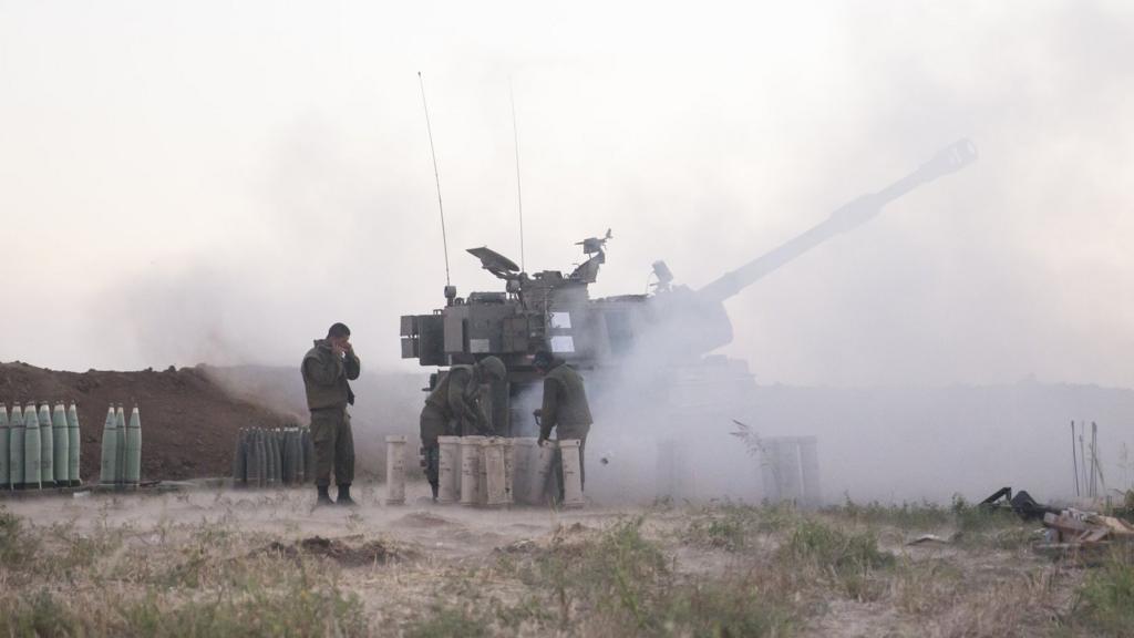 Israeli soldiers operate an artillery unit on Tuesday