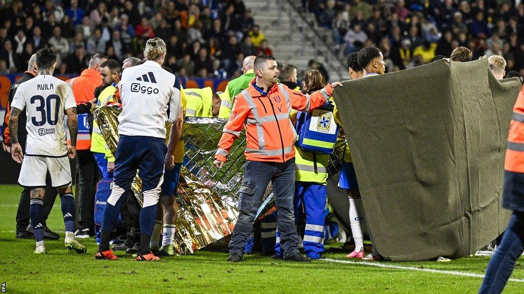 Screens are put up around Etienne Vaessen while he is cared for by medical staff