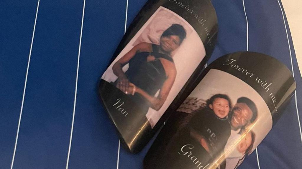 A picture of Thomas' shin pads with pictures of her grandparents on each. Each shin pad has the words, 'Forever with me...' included with the pictures.