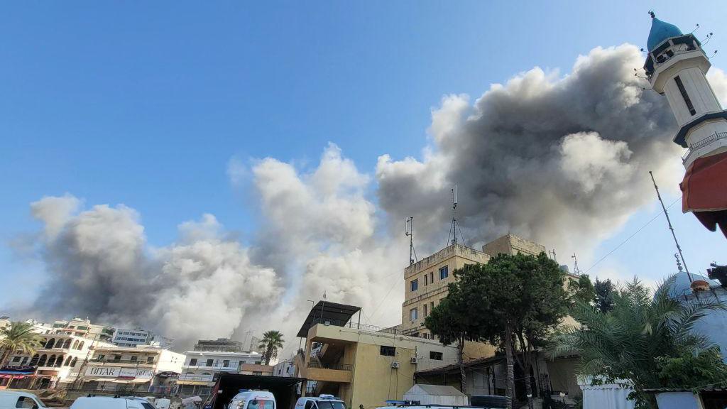 Smoke billows above buildings during Israeli airstrikes in Nabatieh.