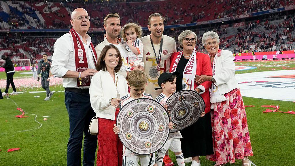 Kane celebrated with his whole family, including parents Patrick (far left) and Kim (second right)