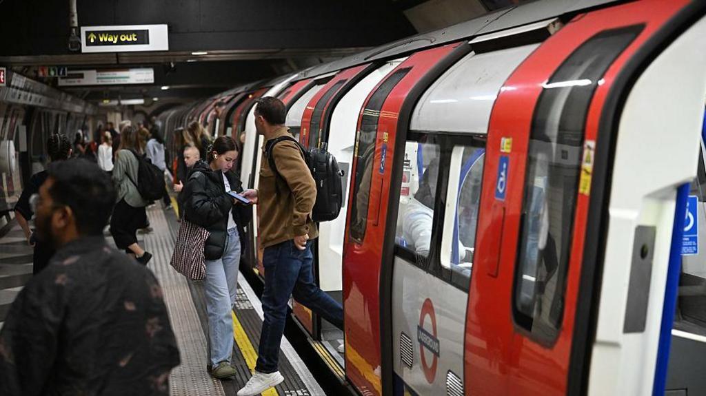 People getting on and off the tube.