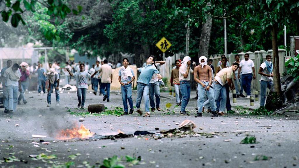 Students from a western Caracas technical school confront police on June 10, 1992 during anti-government riots.