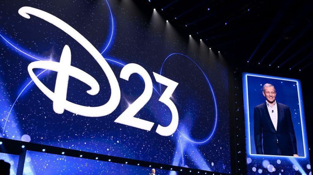 D23 logo and picture of The Walt Disney Company CEO Bob Iger