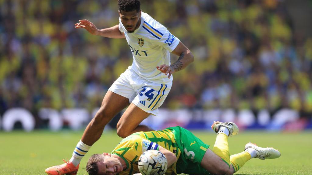 Georginio Rutter of Leeds United clashes with Kenny McLean of Norwich City during the Sky Bet Championship Play-Off Semi-Final 1st Leg match between Norwich City and Leeds United at Carrow Road on May 12, 2024 in Norwich, England