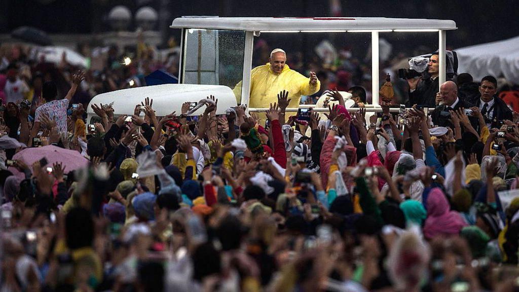 Pope Francis greets the crowd from his popemobile following his Mass in Manila in 2015