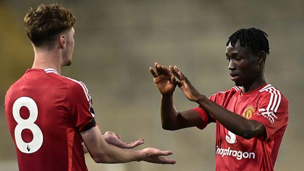 Sekou Kone celebrates scoring his side's fourth goal in their PL2 play-off victory against Everton with Tyler Fletcher