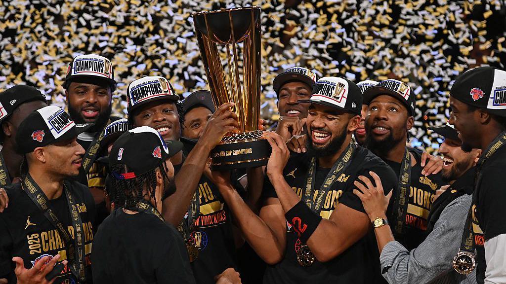 New York Knicks players holding the NBA Championship trophy